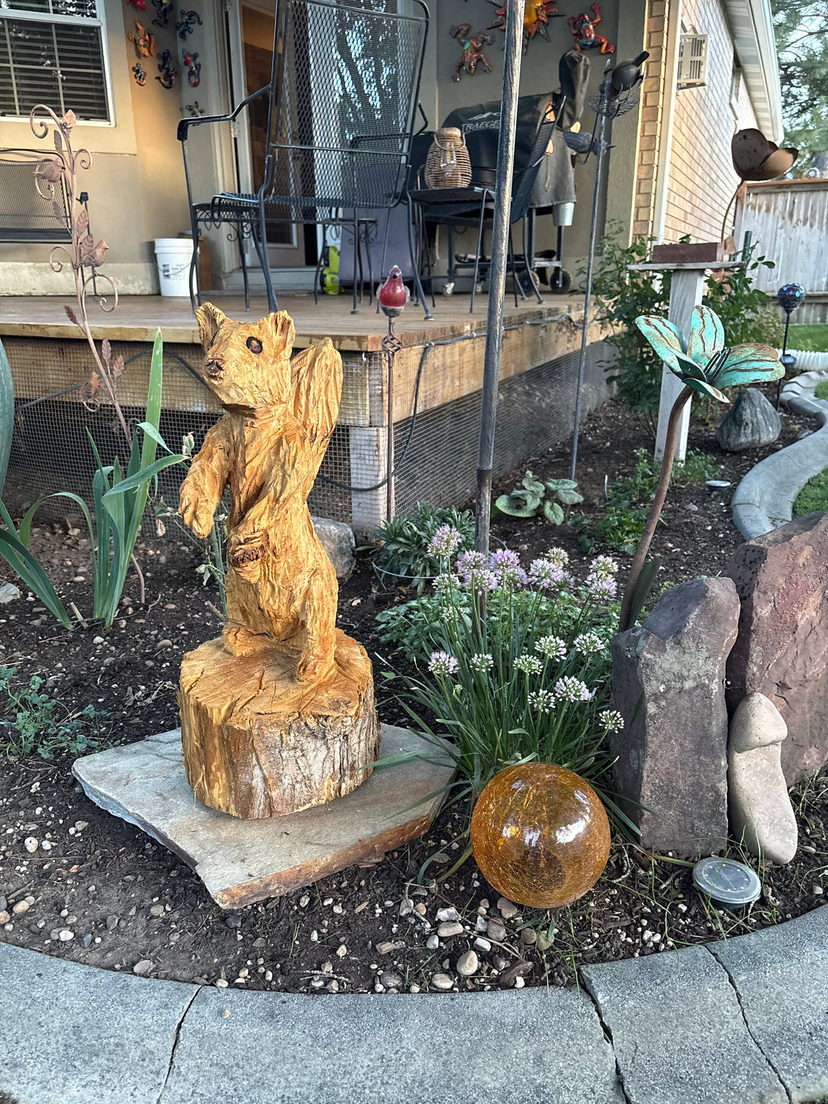 Wood carved bear sculpture in garden setting